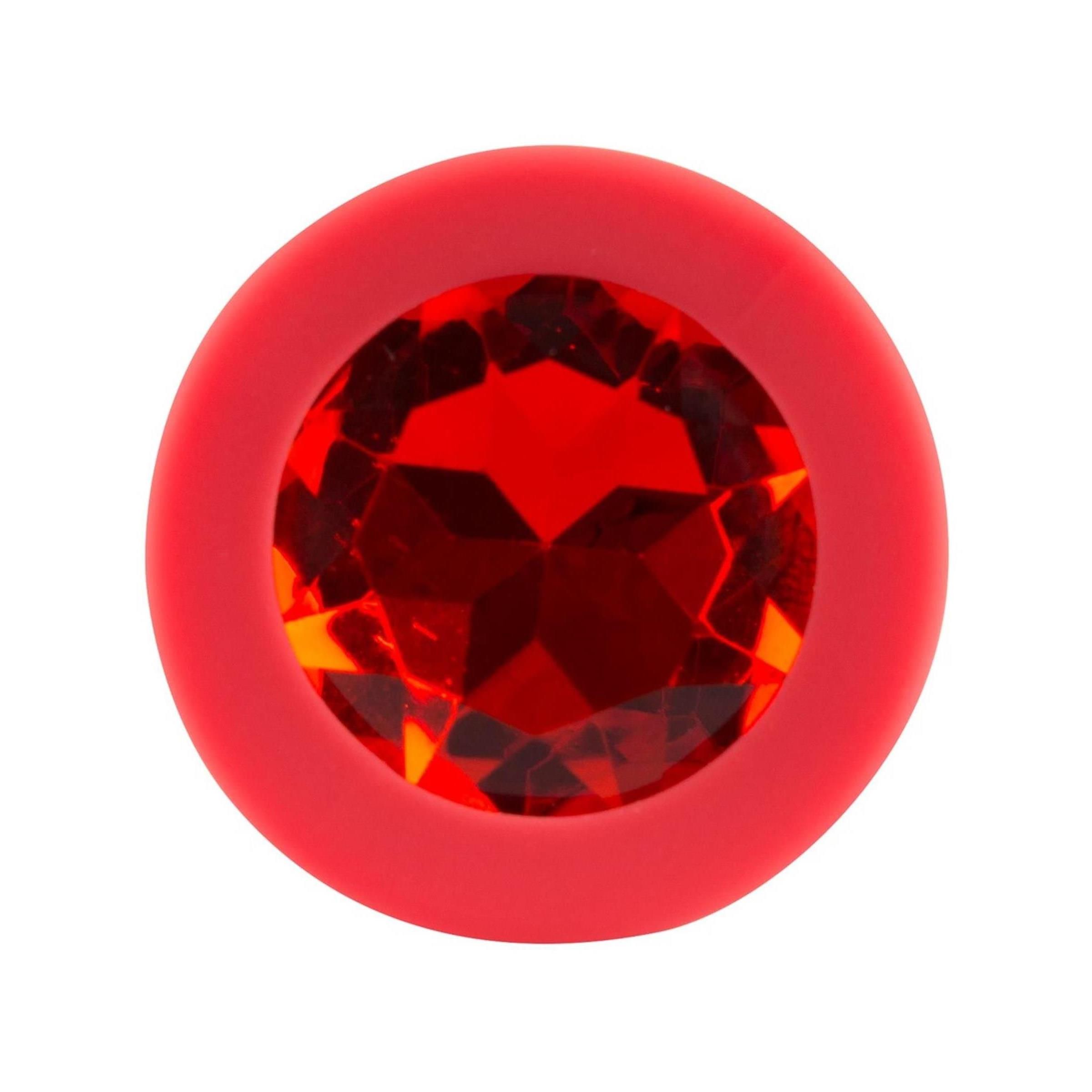 Plug rosso con pietra rossa. Base rotonda con pietra. Vista dall'alto.