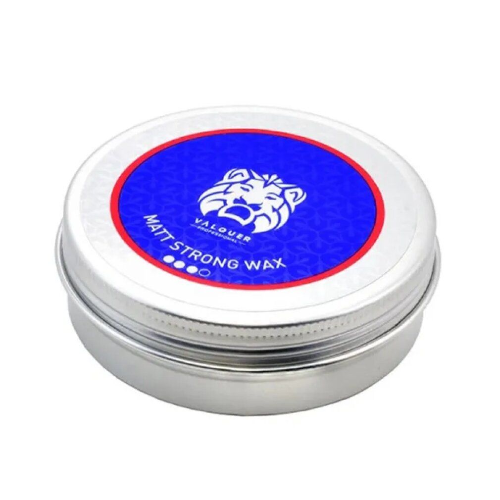 Barattolo rotondo argentato con coperchio blu. Scritta "MATT STRONG WAX" e logo. Anello rosso e blu attorno al logo.