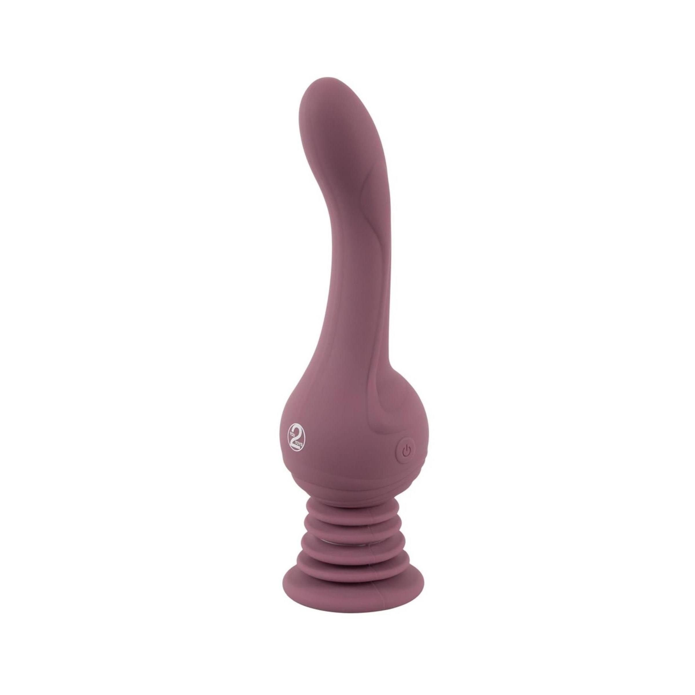 Vibratore lilla con base scanalata e forma curva. Logo '2' sul corpo. Orientamento verticale, su sfondo bianco.
