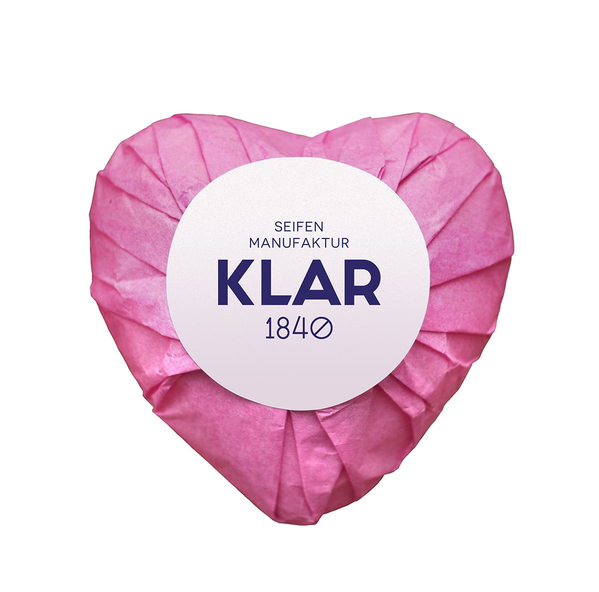 Sapone a forma di cuore avvolto in carta rosa. Etichetta bianca con "KLAR" e "1840".