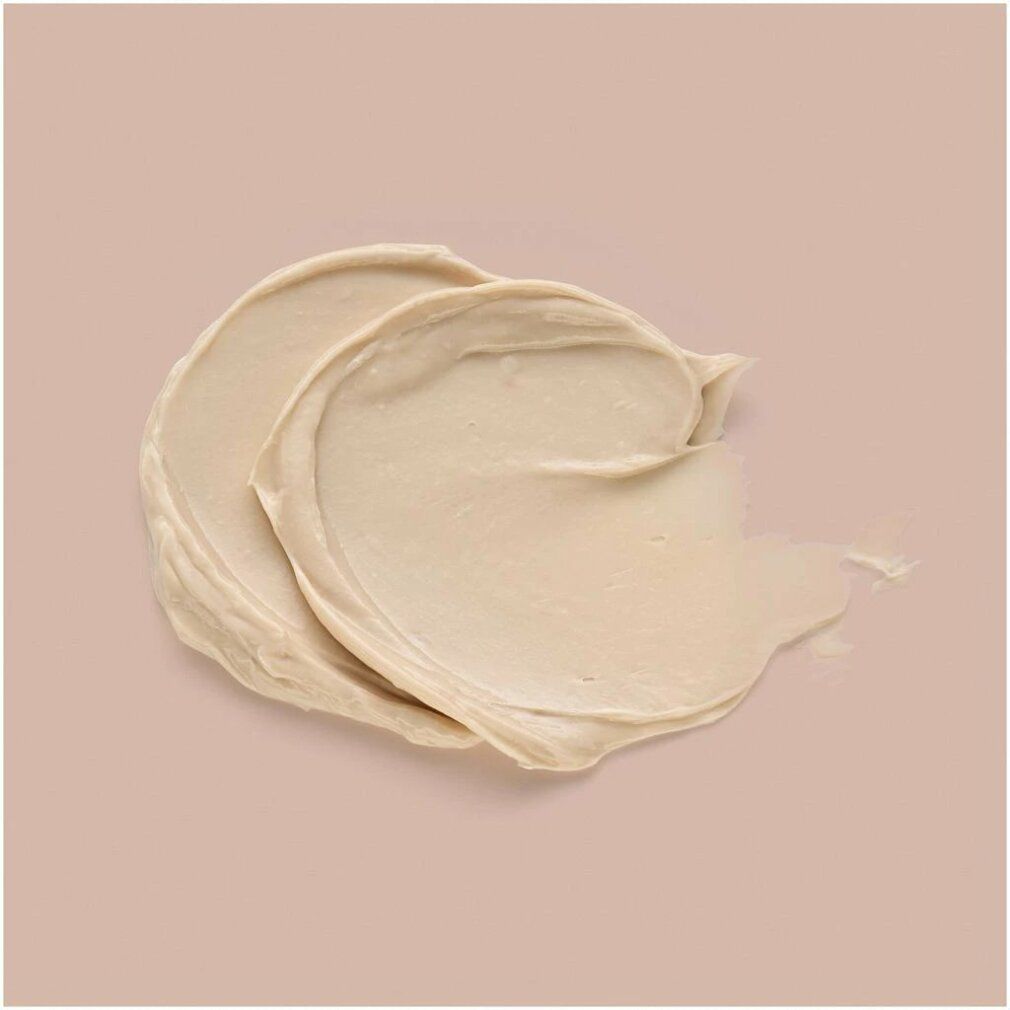 Due strisce di prodotto color crema su sfondo beige. Consistenza della pasta chiaramente visibile.