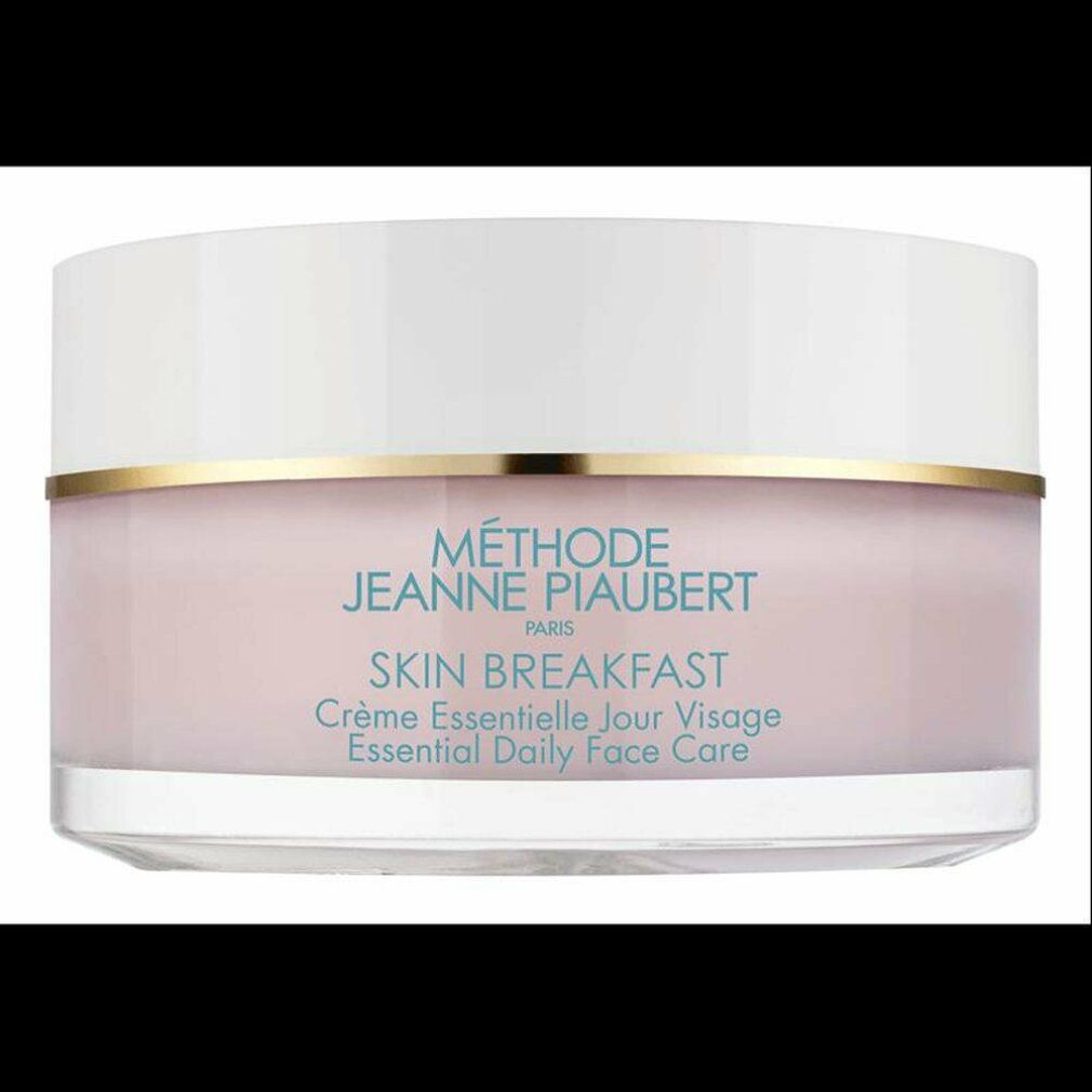 Vasetto di crema con coperchio bianco e contenuto rosa. Anello dorato. Scritta SKIN BREAKFAST.