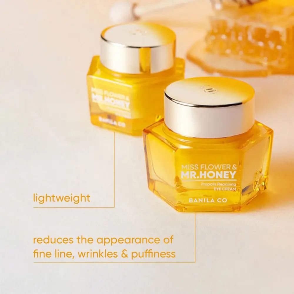 Due vasetti di crema per gli occhi dorati. Scritta: Miss Flower & Mr. Honey. Testo: Riduce l'aspetto di linee sottili, rughe e gonfiori.