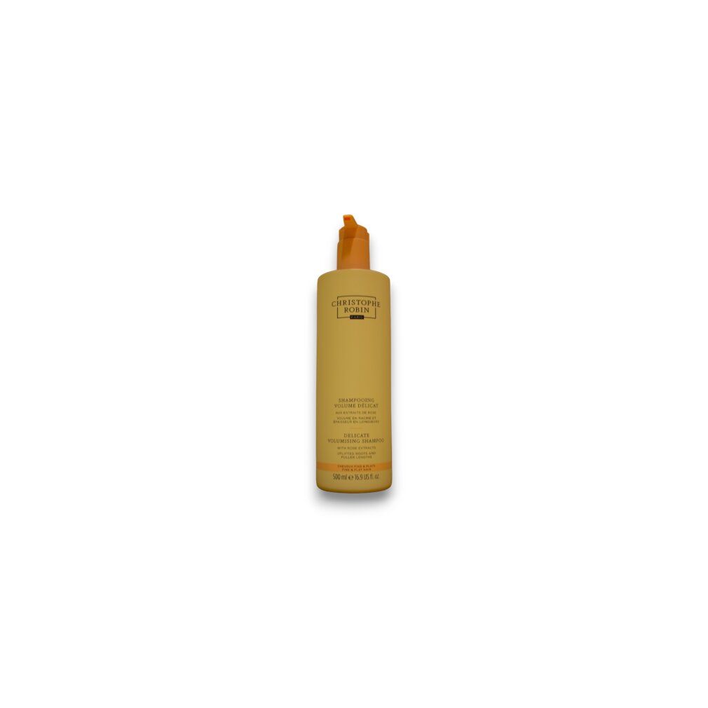 Flacone di shampoo beige con tappo arancione. Testo: Christophe Robin, Delicate Volumising Shampoo, con estratti di rosa.