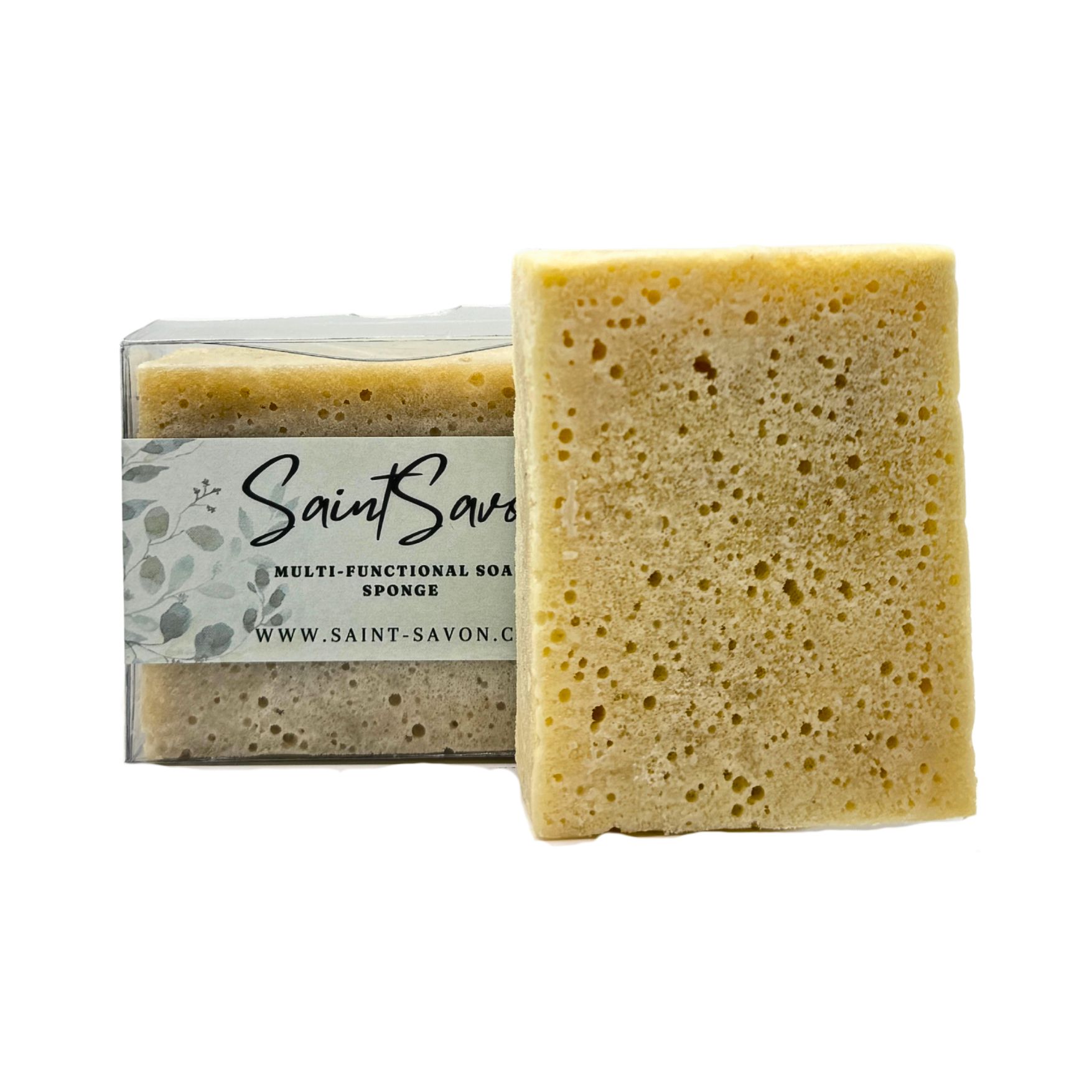 Spugne rettangolari, una nella confezione, una accanto. L'etichetta riporta "Saint Savon", "Multi-Functional Soap Sponge" e il sito web.