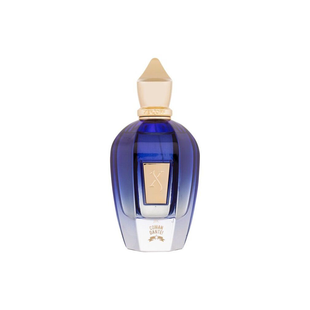 Flacone di profumo blu con tappo dorato. Etichetta dorata con 'X' e scritta 'COMANDANTE'.