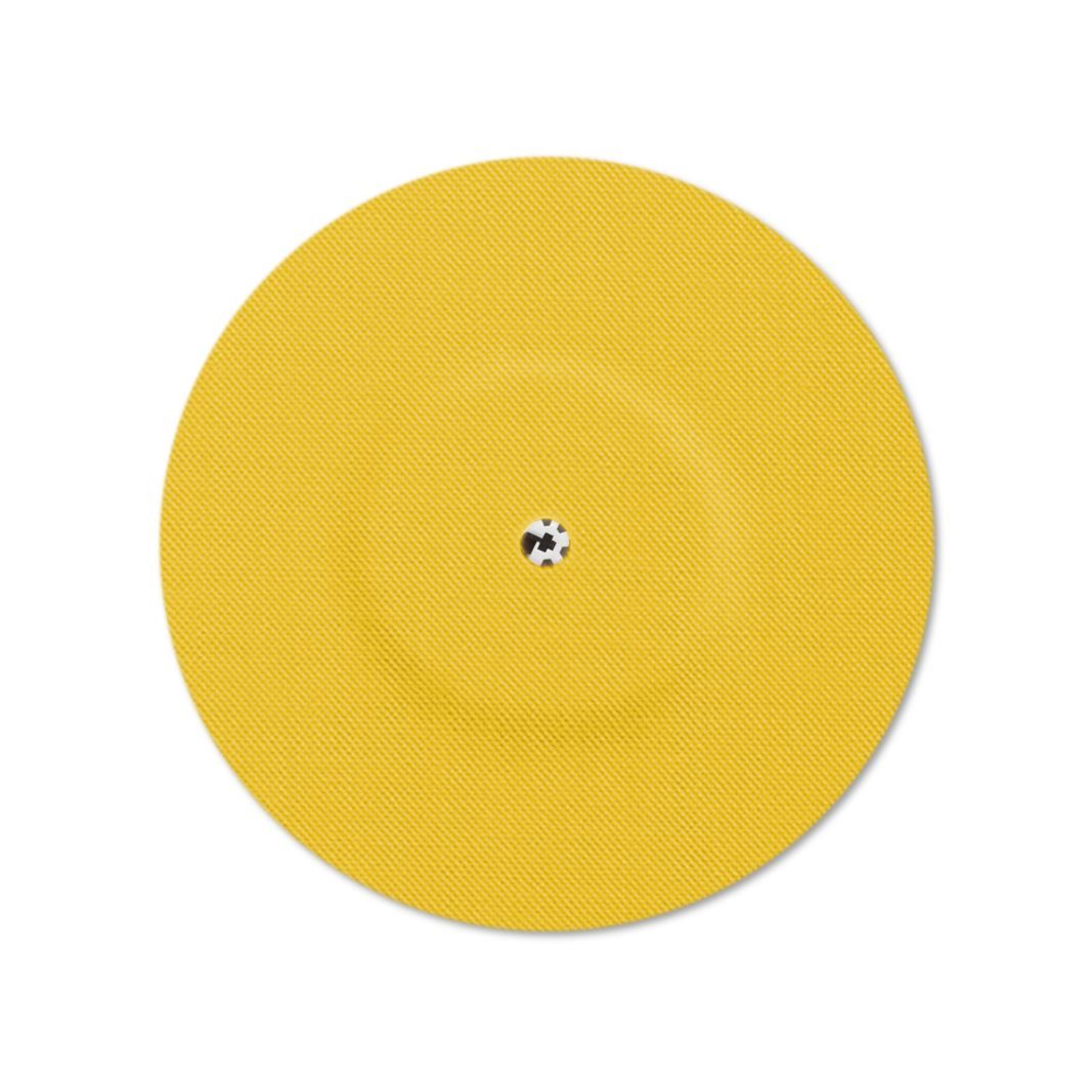 Cerotto giallo con foro di ventilazione. Elemento centrale con piccolo punto scuro. Forma rotonda.