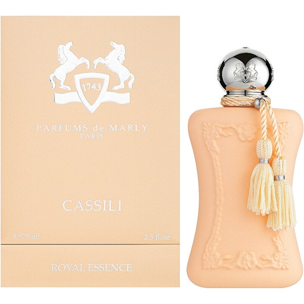 Flacone di profumo con nappe e confezione. Flacone arancione chiaro, confezione beige chiaro. Logo e scritta "Cassili" visibili.