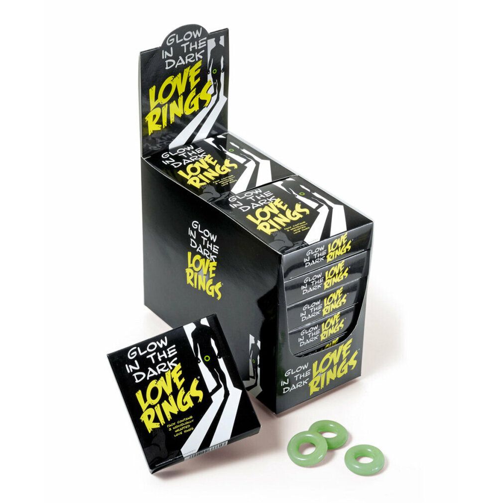 Scatola nera con scritta: Glow in the Dark Love Rings. Tre anelli verdi accanto.