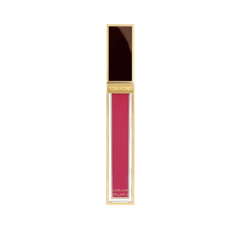 Tubo di lucidalabbra con tappo dorato. Contenuto rosa. Marchio Tom Ford.