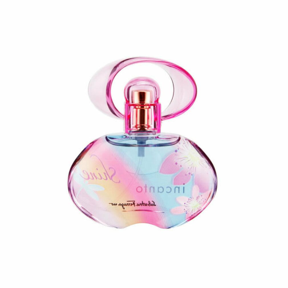 Flacone di profumo con tappo rosa. Scritta: Incanto Shine, Salvatore Ferragamo. Motivo floreale sul flacone.