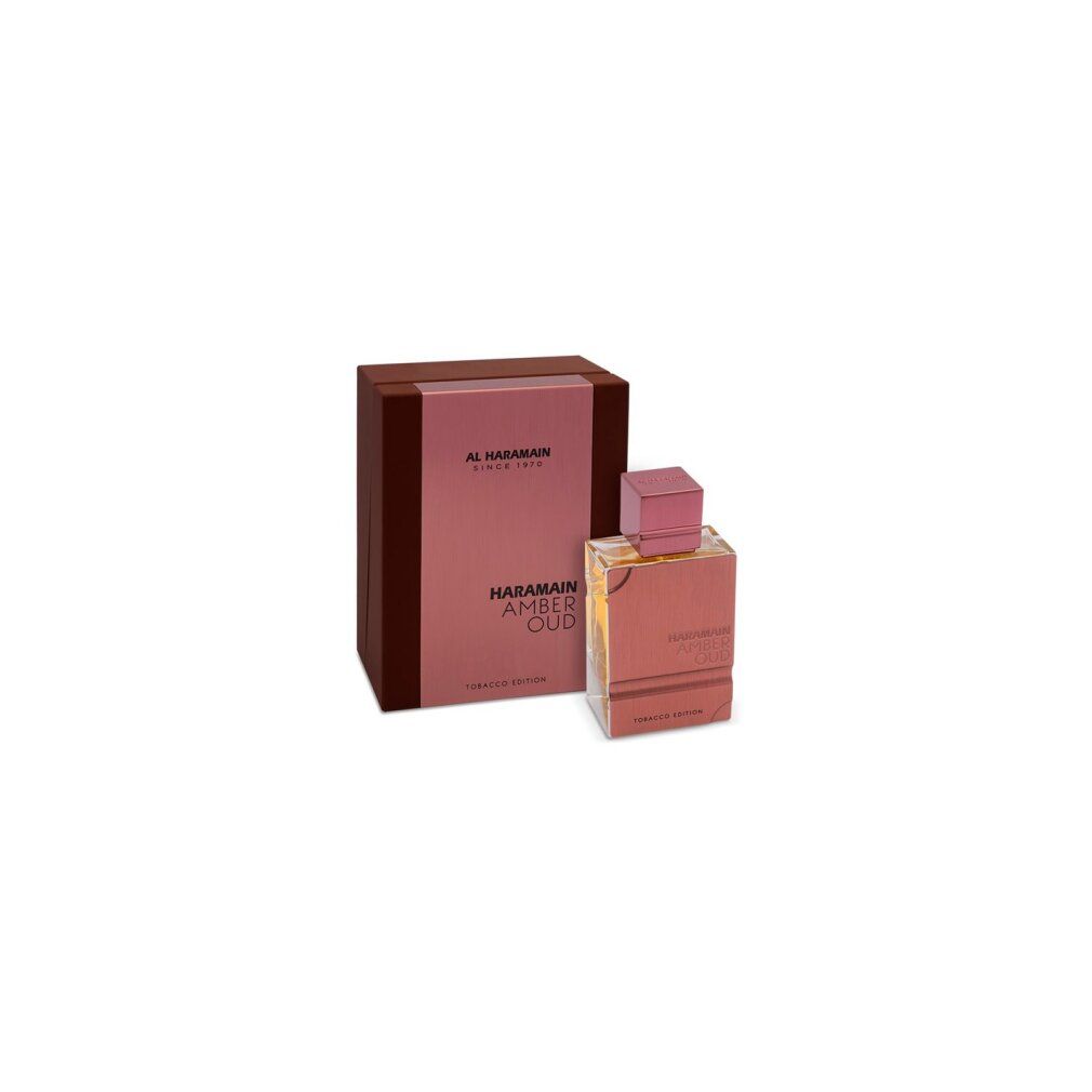 Flacone di profumo e confezione. Scritta: Al Haramain, Amber Oud Tobacco Edition. Flacone e scatola nei toni del marrone e dell'oro.