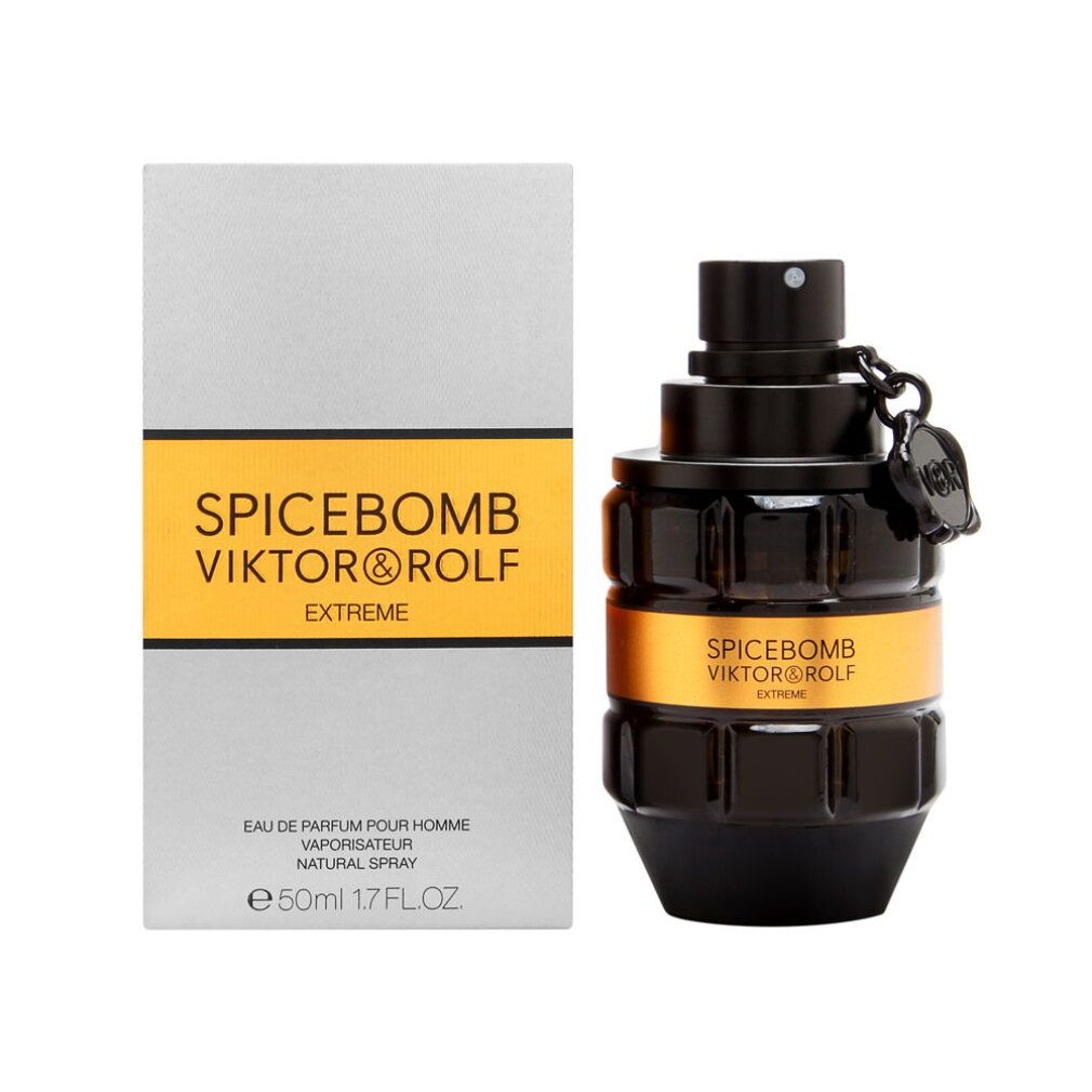 Flacone nero con etichetta dorata e scritta. Accanto, una scatola grigia con una striscia gialla e scritta.