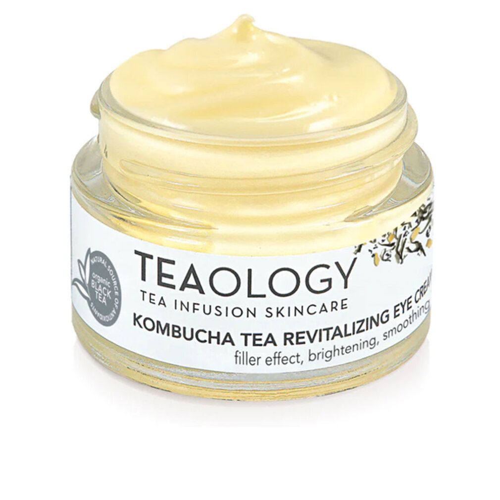 Vasetto in vetro con crema giallastra. L'etichetta riporta "TEAOLOGY", "Kombucha Tea Revitalizing Eye Cream".