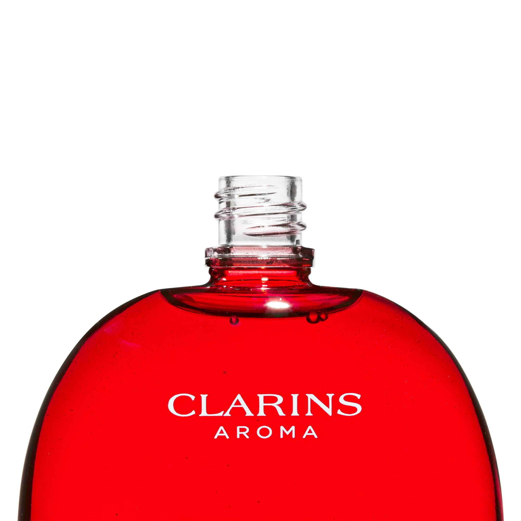 Flacone rosso senza tappo. Scritta: Clarins Aroma.