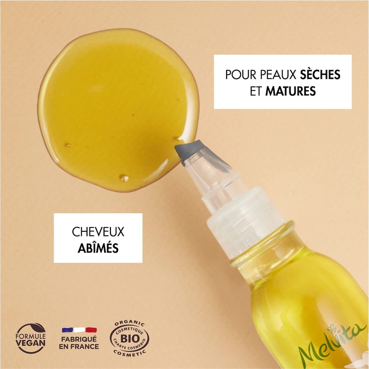 Olio giallo con applicatore. Testo: Per pelli secche e mature, capelli danneggiati. Vegano, prodotto in Francia, cosmetici bio.