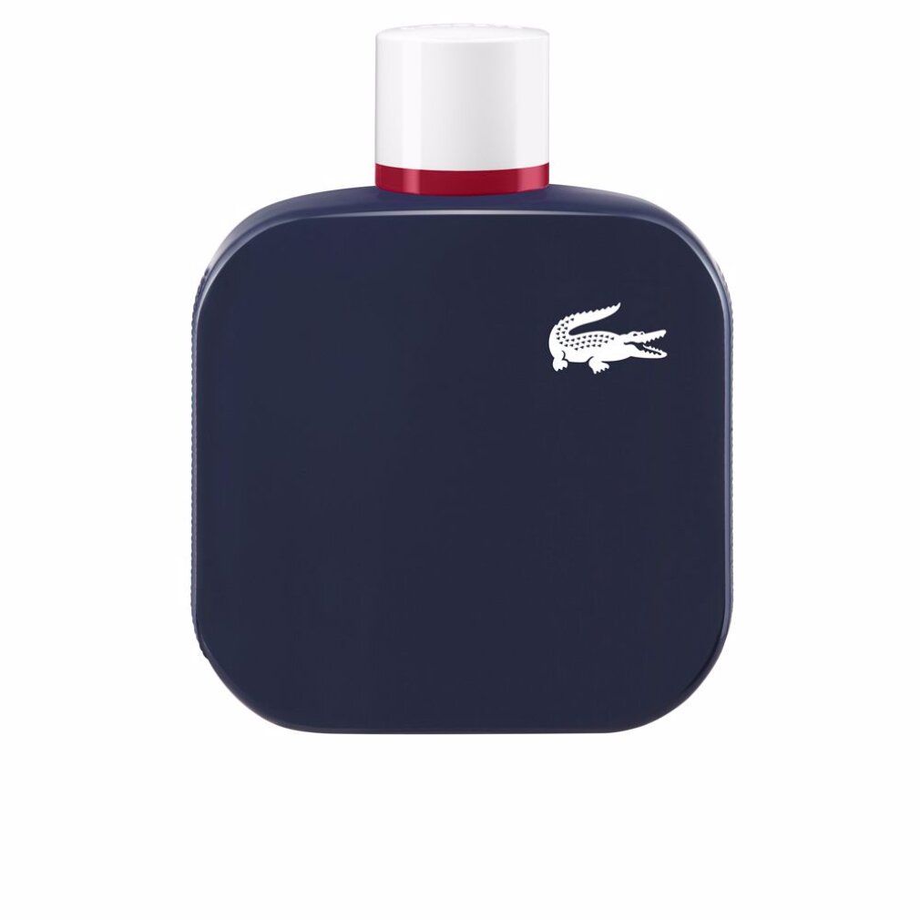Flacone blu scuro con tappo bianco e anello rosso. Logo coccodrillo bianco. Forma quadrata con angoli arrotondati.