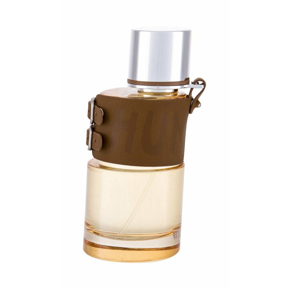 Flacone di profumo con custodia in pelle marrone e tappo argentato. Scritta visibile.