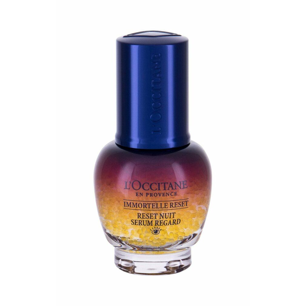 Flacone di siero con tappo blu. Scritte: L'Occitane, Immortelle Reset, Reset Nuit Serum Regard. Sferette gialle nella parte inferiore.
