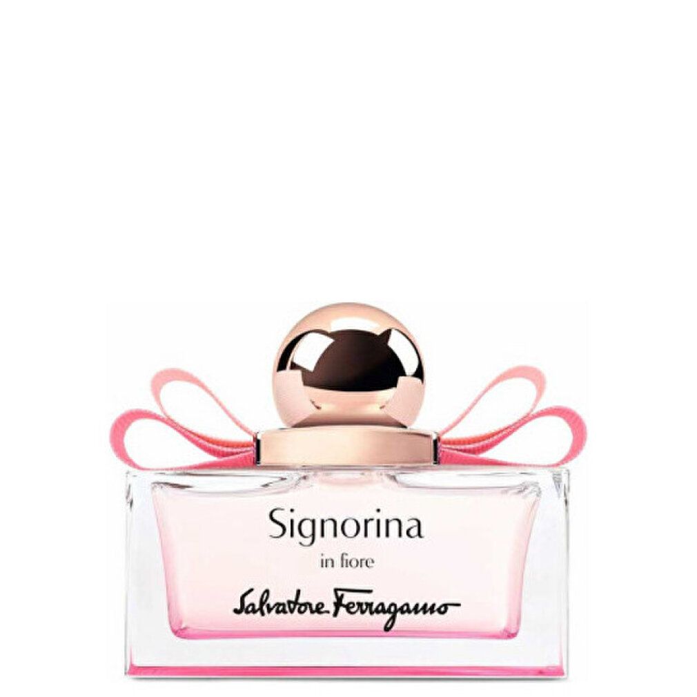 Flacone di profumo con liquido rosa, fiocco rosa e tappo dorato. Scritta: Signorina in Fiore, Salvatore Ferragamo.