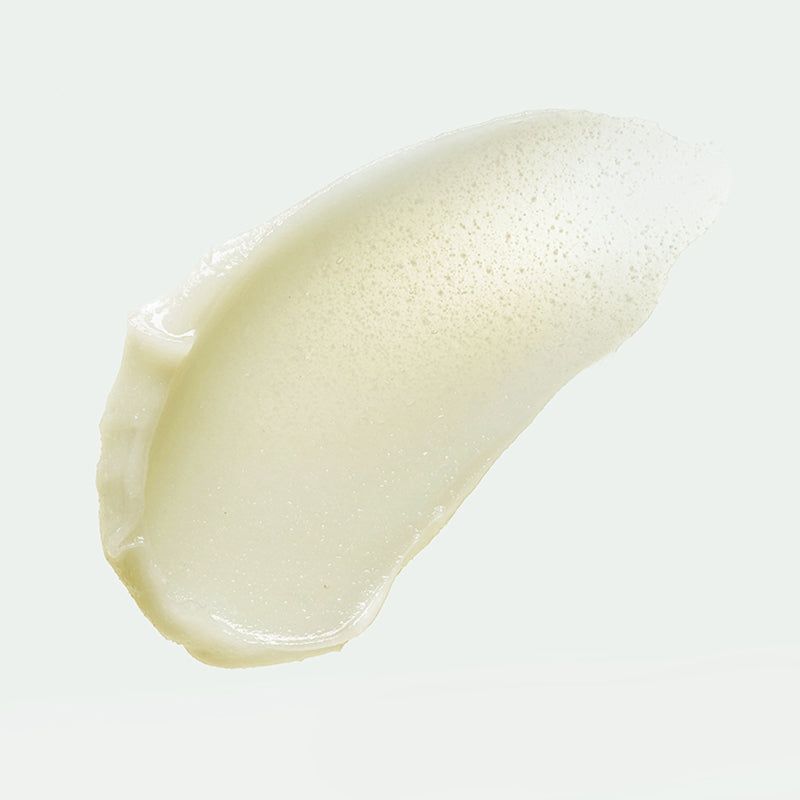 Traccia di prodotto cremoso chiaro. Texture con piccole particelle.