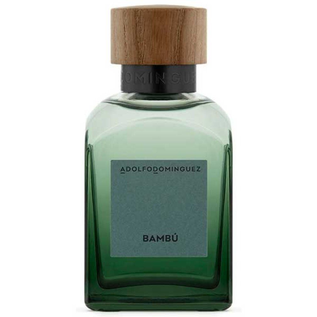 Flacone di vetro verde con tappo in legno. L'etichetta riporta la scritta "Bambú" e il nome del marchio "ADOLFO DOMINGUEZ".