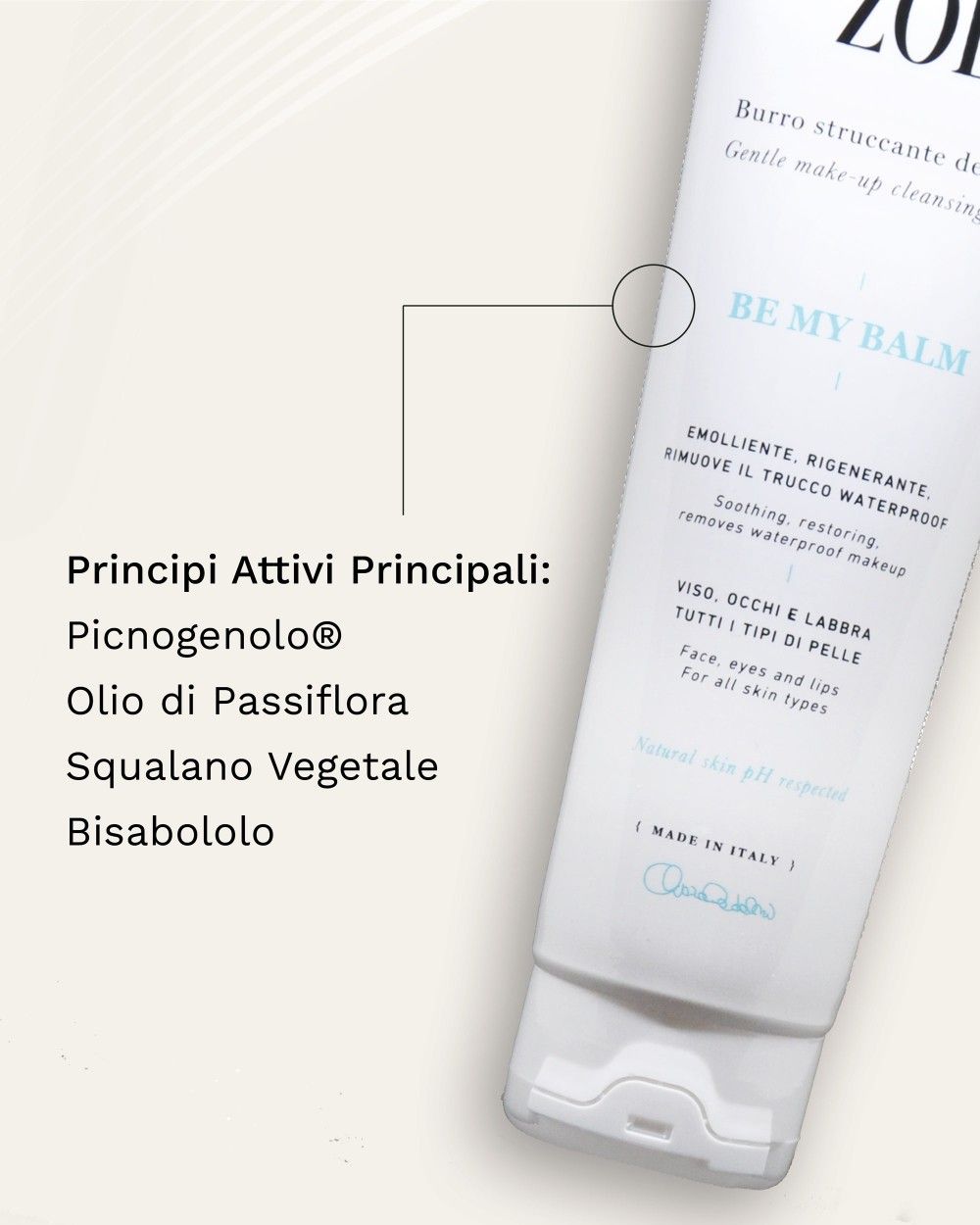 Tubo bianco con testo. Scritta: ZOE, BE MY BALM. Per viso, occhi e labbra. Con testo e cerchi.