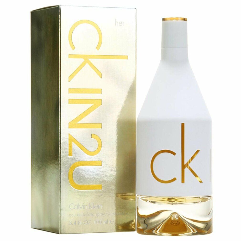 Flacone di profumo e confezione. Flacone bianco, scritta "ck". Confezione dorata, scritta "CK IN2U her".