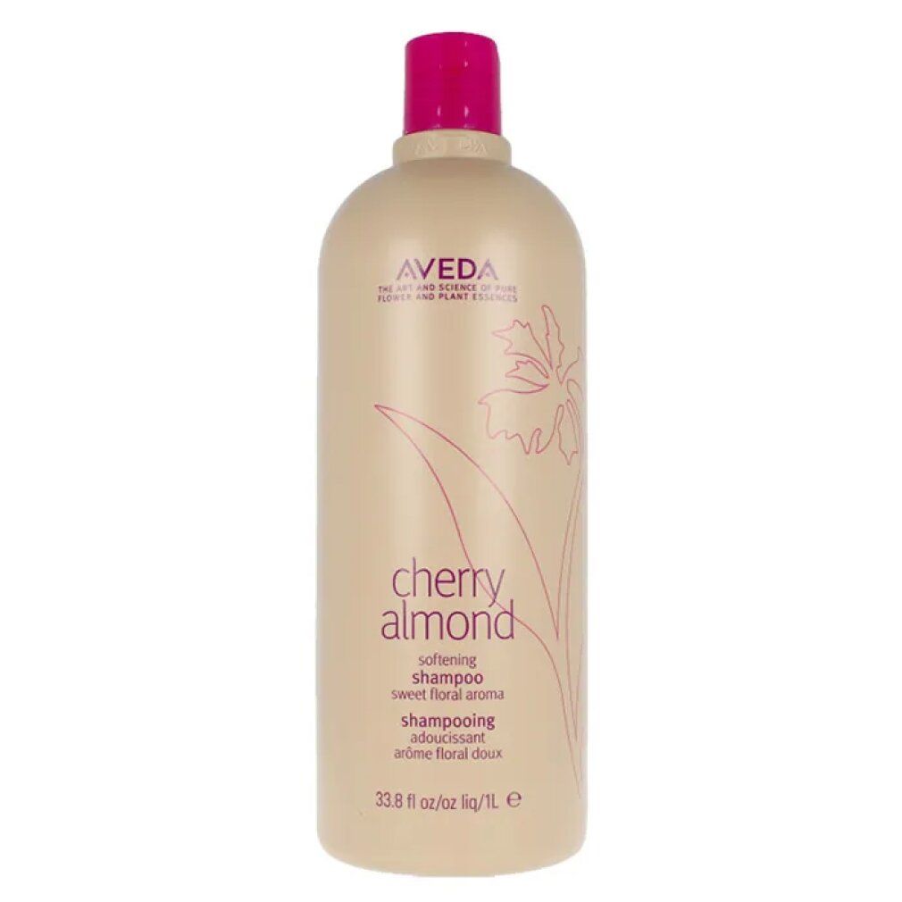 Flacone di shampoo beige con tappo rosa. Scritta: Aveda, Cherry Almond, Shampoo. Design floreale.