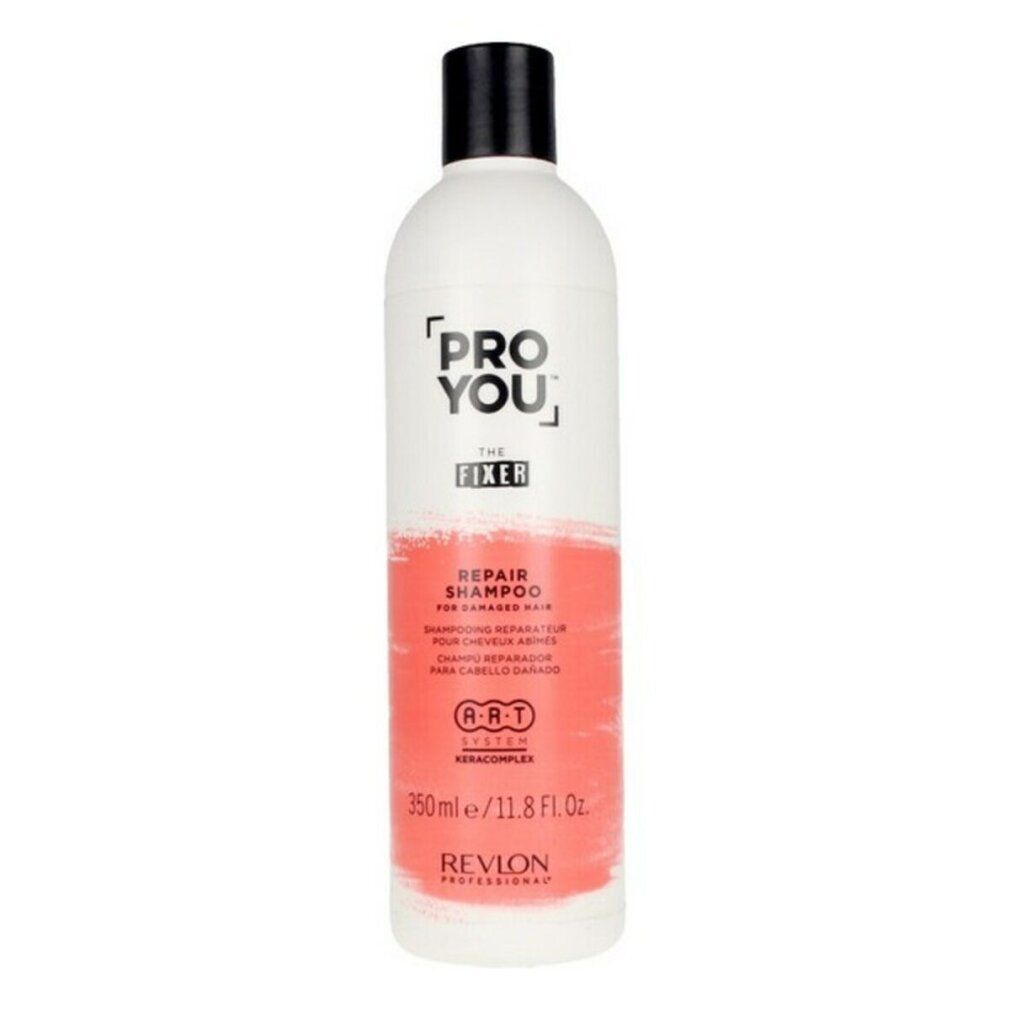 Flacone bianco con tappo nero. Scritta: PRO YOU THE FIXER REPAIR SHAMPOO. Area colorata rossa. Revlon Professional.