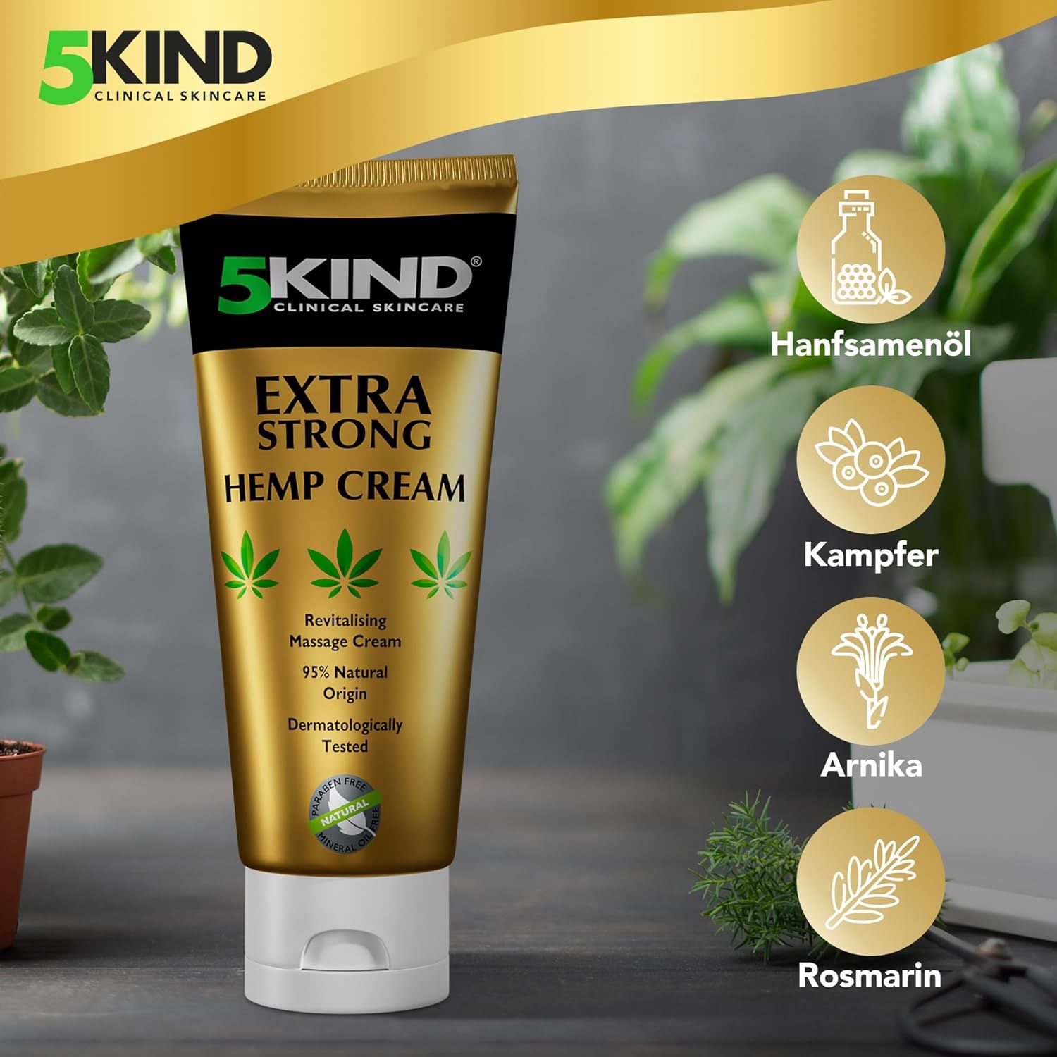 Tubo dorato con scritta: 5kind, Extra Strong Hemp Cream. Olio di semi di canapa, canfora, arnica, rosmarino. Piante verdi sullo sfondo.