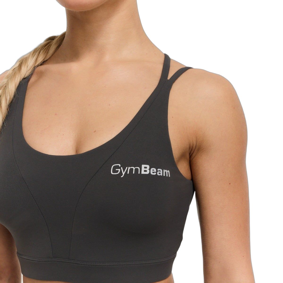 Vista dettagliata di un reggiseno sportivo grigio scuro con spalline incrociate e logo GymBeam.
