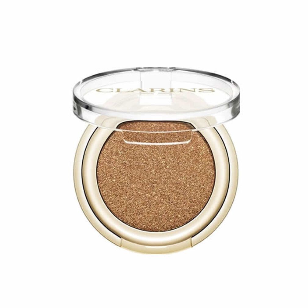 Ombretto Clarins. Astuccio rotondo dorato con ombretto dorato. Coperchio trasparente con logo Clarins.