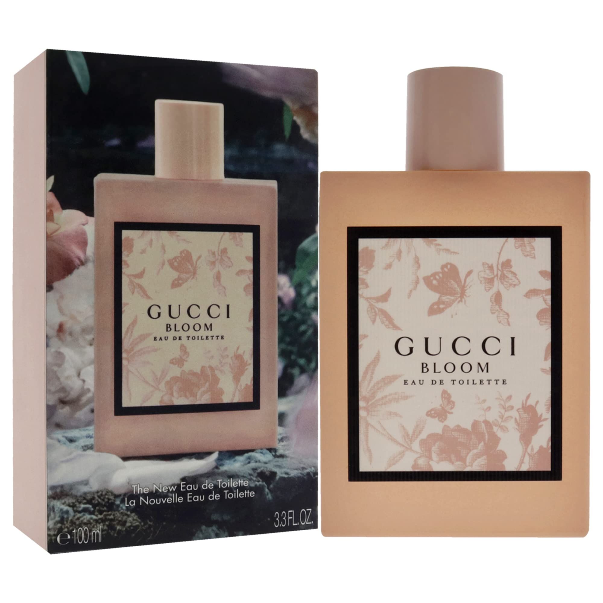 Flacone e scatola rosa. Scritta Gucci Bloom. Cornice nera con motivo floreale. Eau de Toilette.