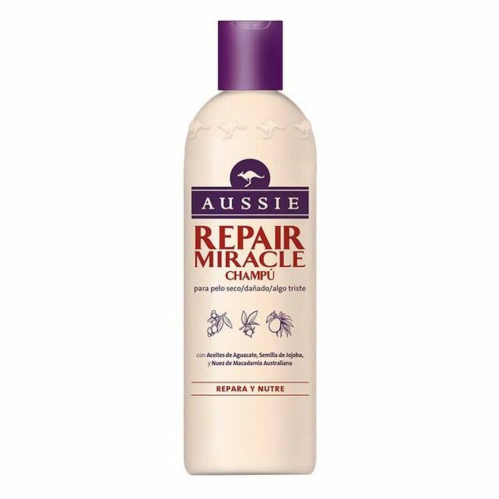 Flacone di shampoo beige con tappo viola. Scritta: Aussie Repair Miracle Champú. Logo canguro.