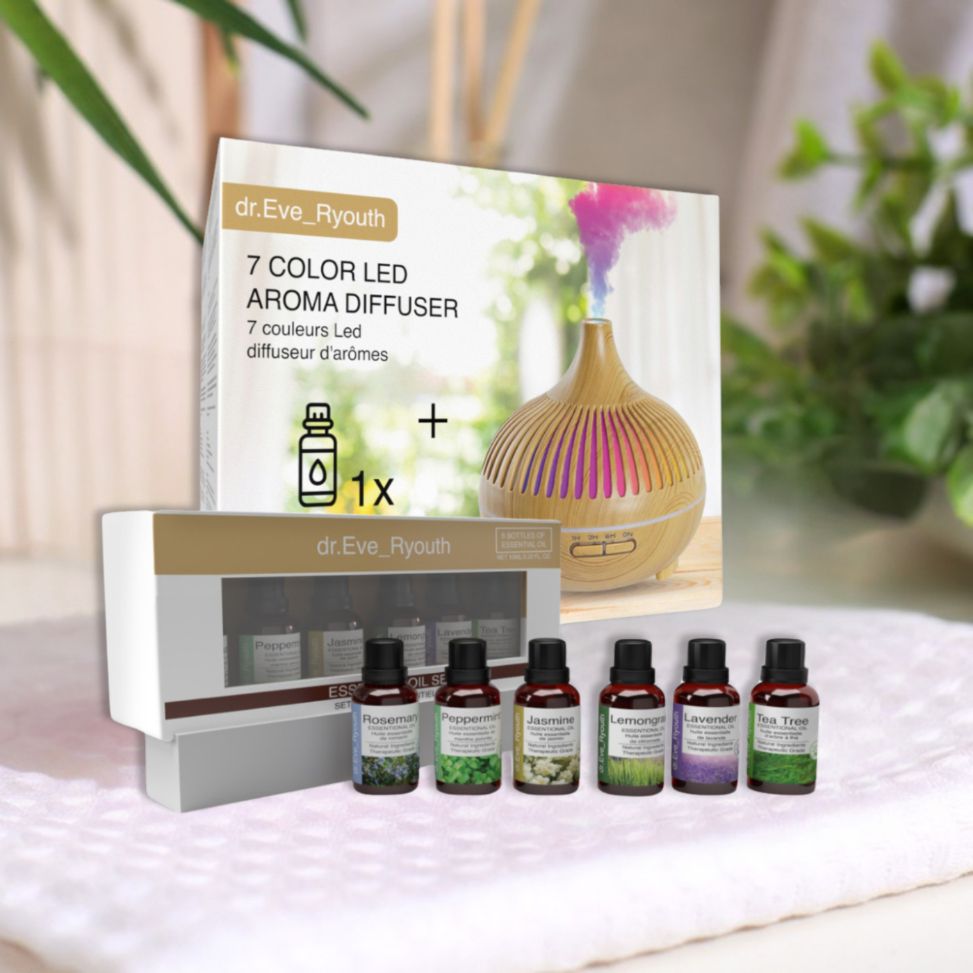 Dr. Eve Ryouth Diffusore Aroma LED 7 colori e 6 oli essenziali. Diffusore effetto legno, vapore colorato, 6 flaconi di olio su telo bianco.