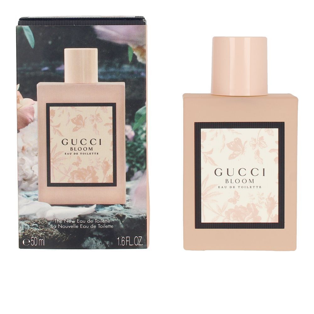Flacone rosa con stampa, accanto alla confezione con motivo floreale. Scritta: Gucci Bloom Eau de Toilette.