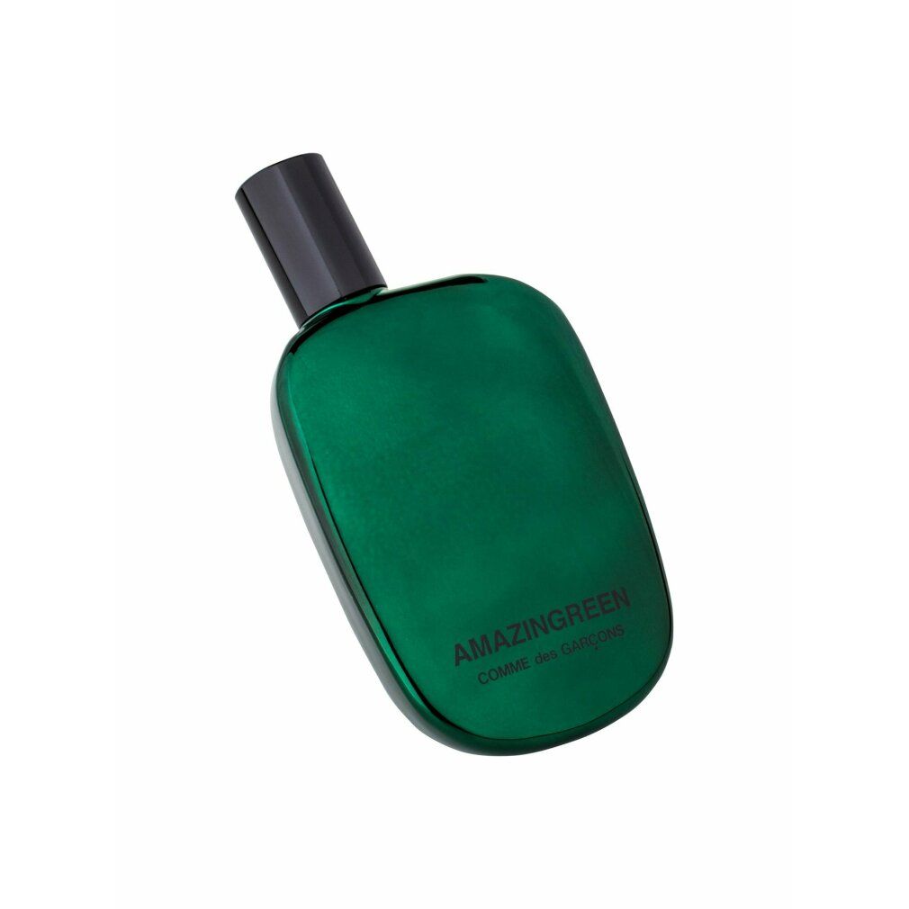 Flacone di profumo verde con tappo nero. Scritta: AMAZINGREEN, COMME des GARÇONS.