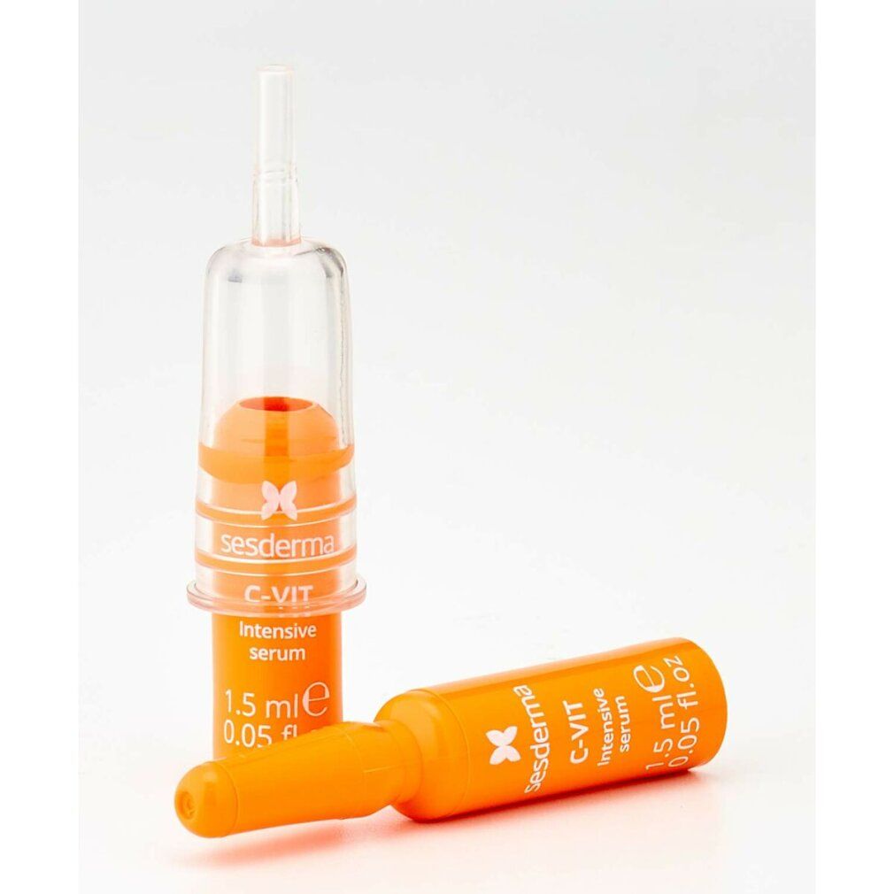 Due fiale arancioni. Scritta: C-VIT Intensive Serum, Sesderma. Una fiala con applicatore.