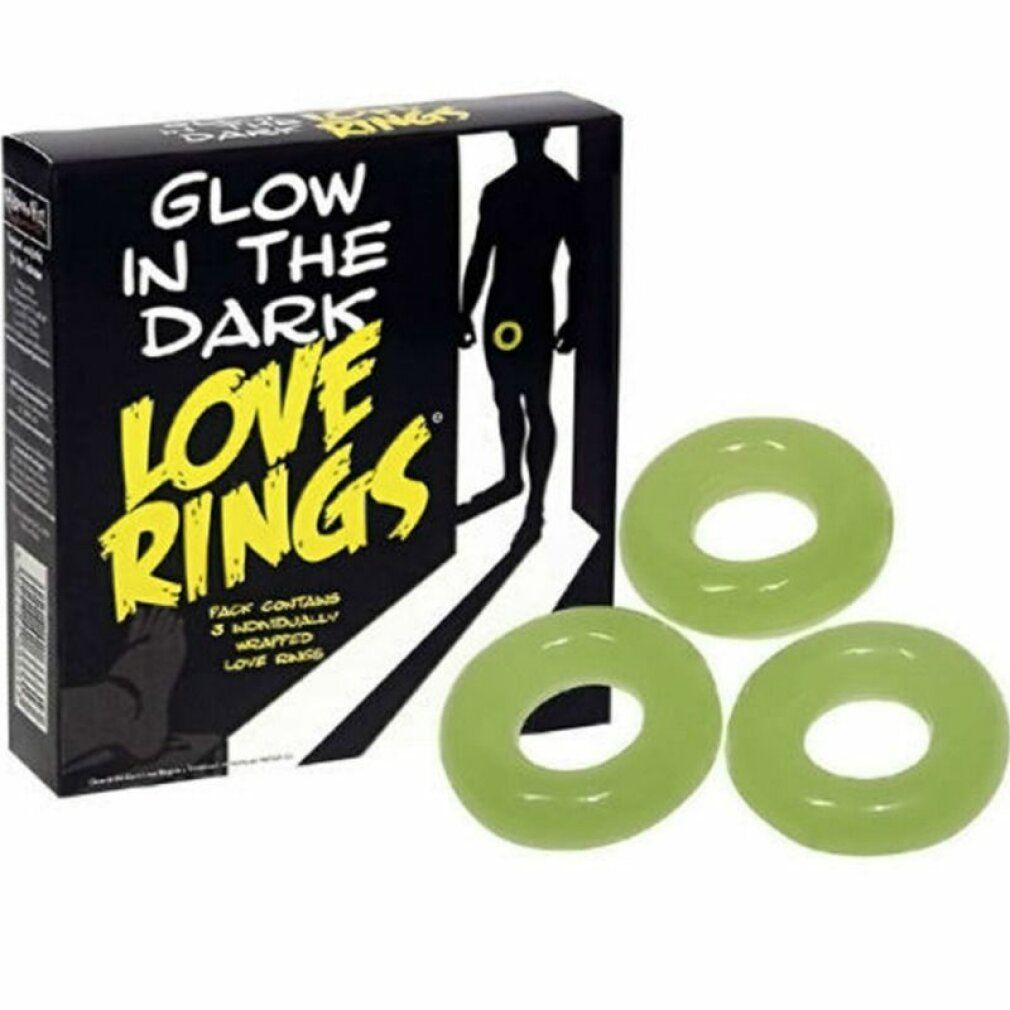 Scatola nera con scritta: Glow in the Dark Love Rings. Tre anelli verdi accanto.
