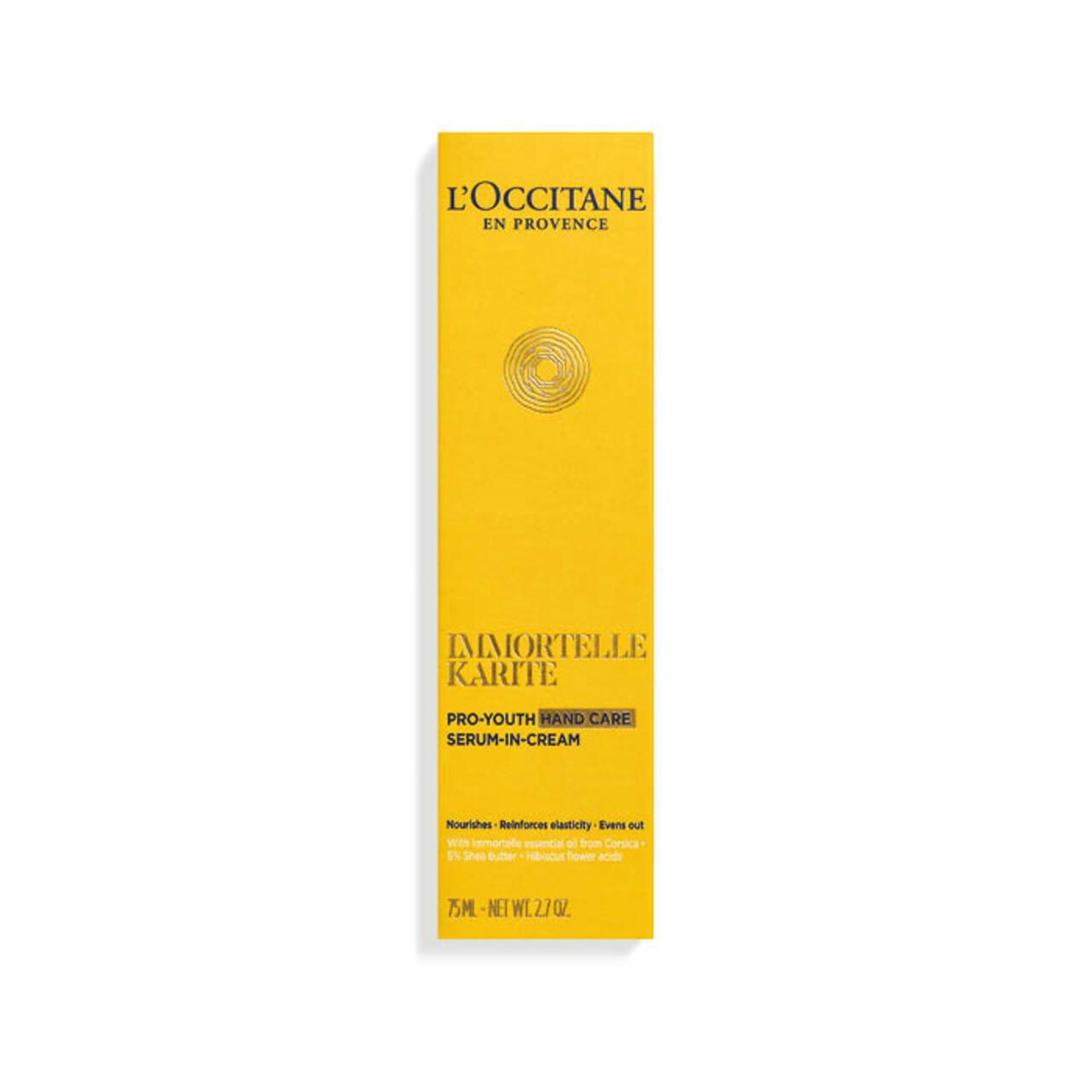 Confezione gialla L'Occitane. Testo: 'Immortelle Karité Pro-Youth Hand Care'.