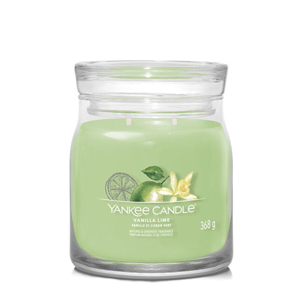 Candela in vetro verde chiaro con coperchio. Etichetta con illustrazione e testo: Yankee Candle Vanilla Lime.