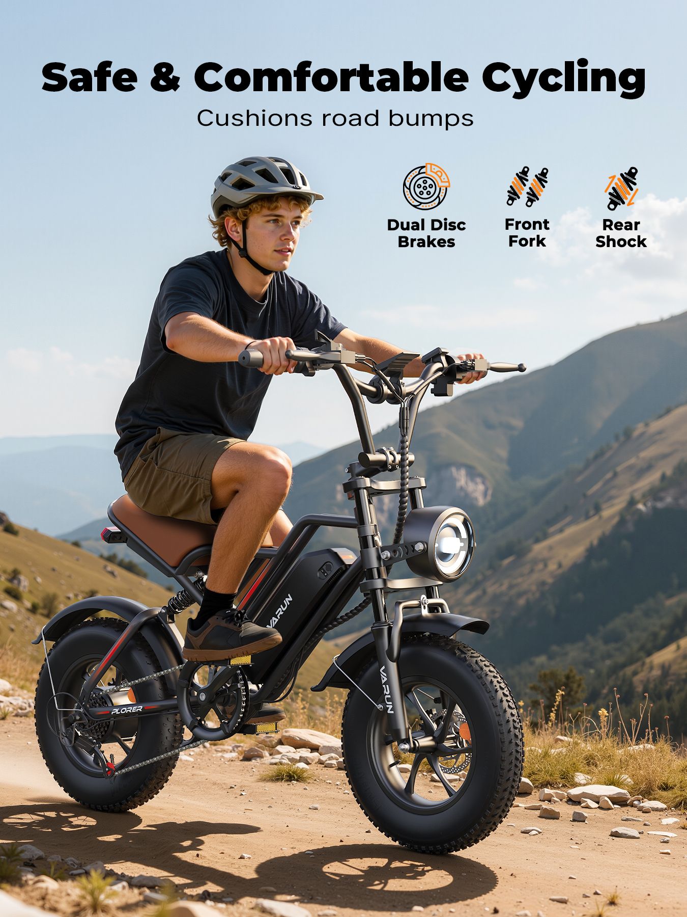 Persona in sella a una e-bike. Bicicletta nera, sella marrone, logo VARUN. Freni a disco doppi, forcella anteriore, ammortizzatore posteriore.