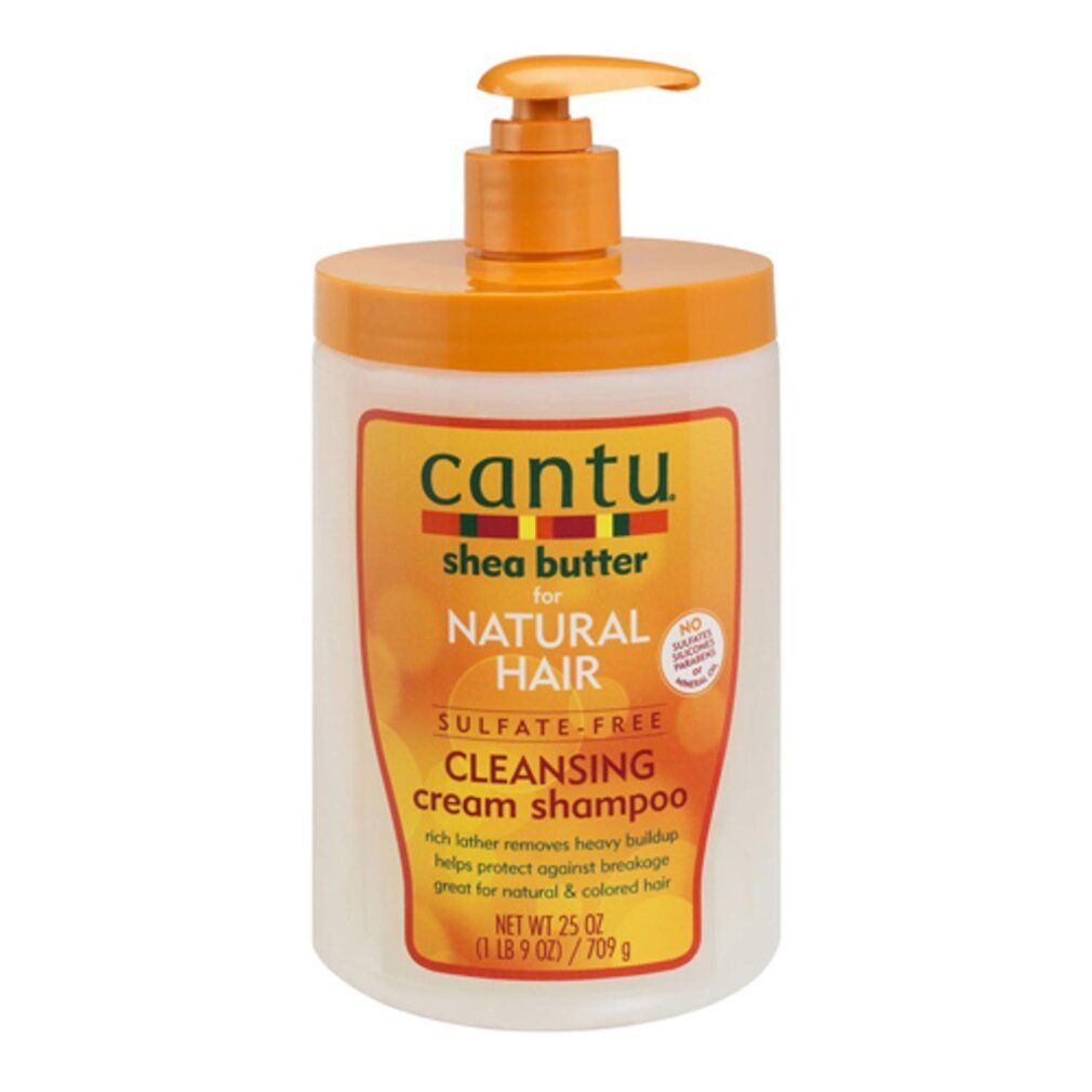 Flacone di shampoo con dosatore a pompa. Scritta: Cantu, Shea Butter, Natural Hair, Cleansing Cream Shampoo. Design arancione e bianco.