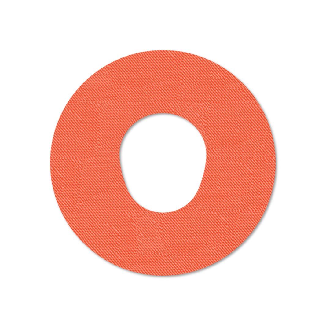 Cerotto rotondo arancione con foro centrale. Superficie tessuta.