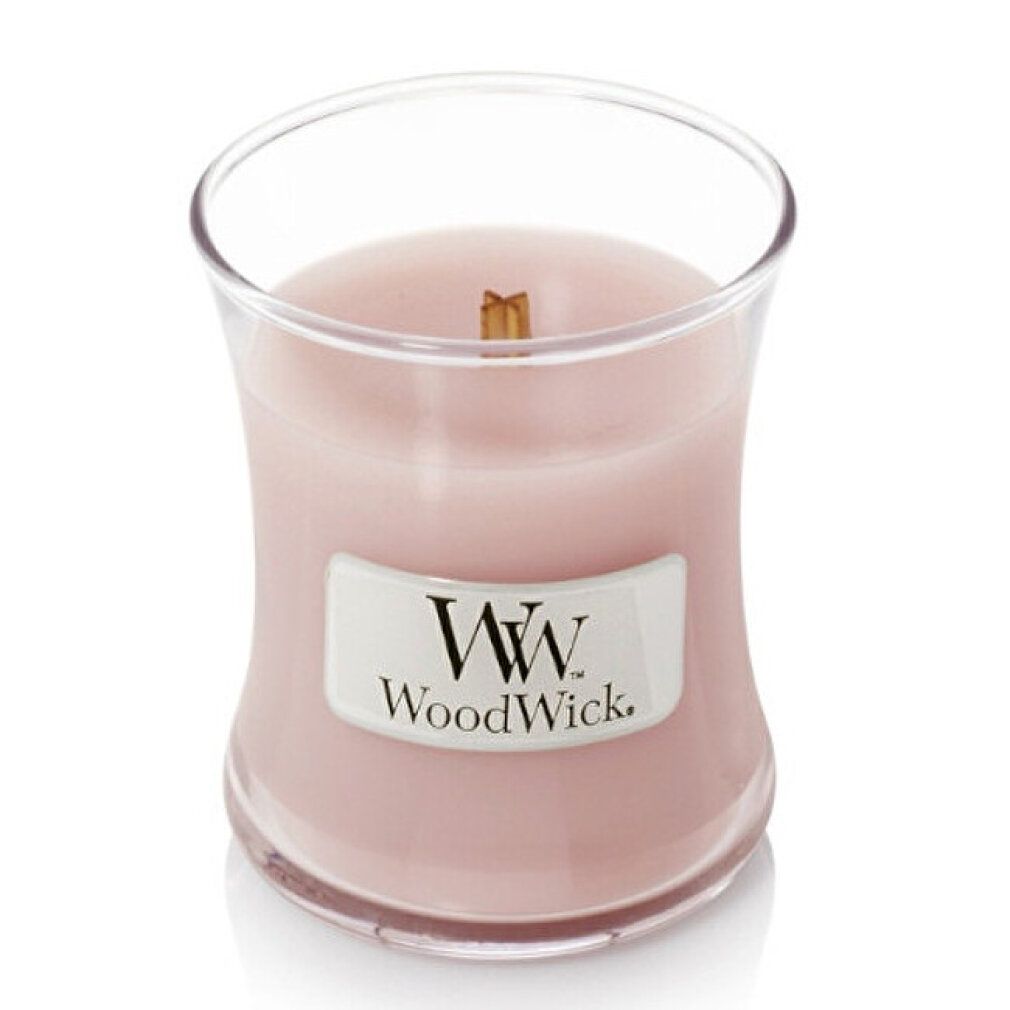Candela a clessidra con stoppino in legno. Cera rosa, contenitore in vetro, etichetta bianca con logo. Aperta, senza coperchio.