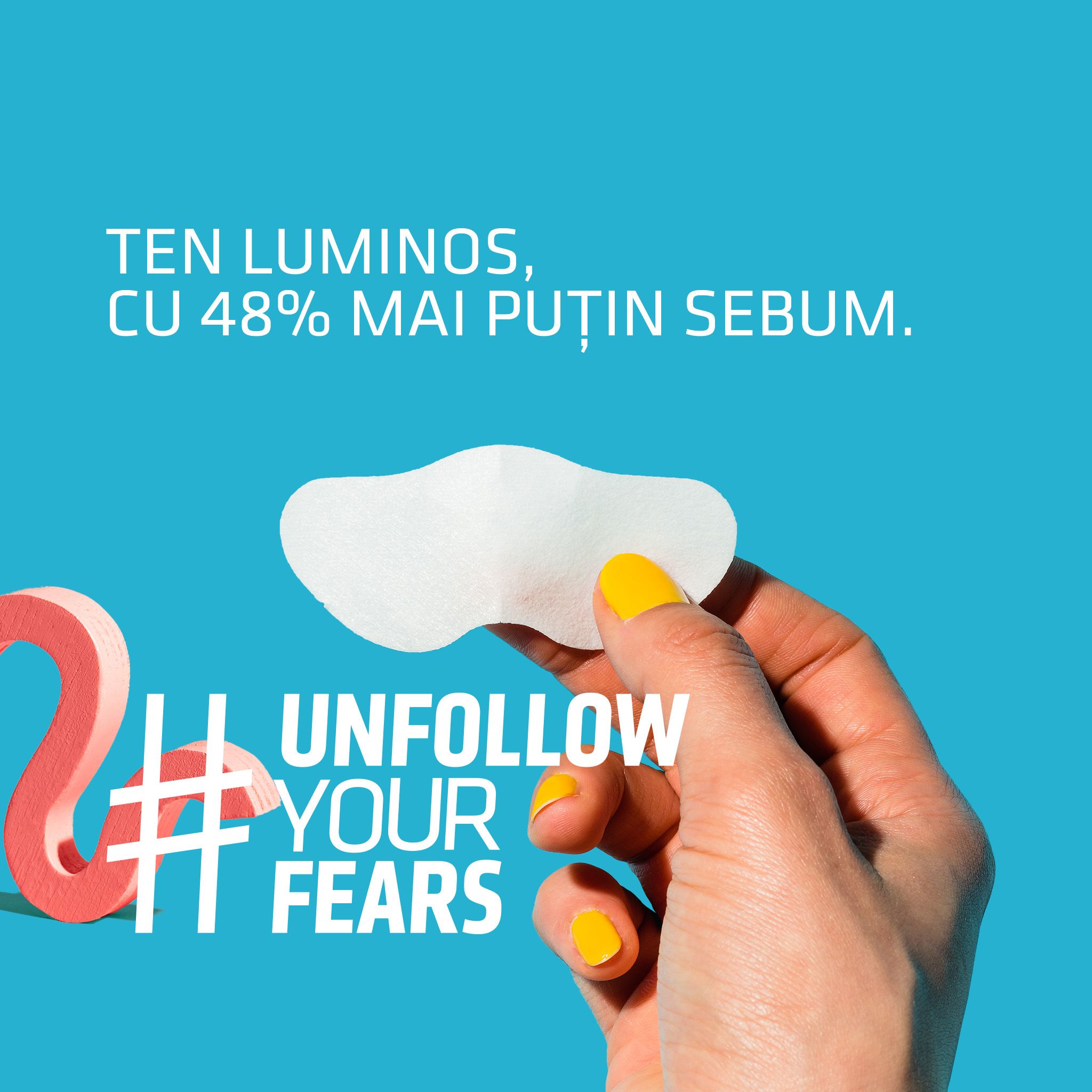 Mano con smalto giallo che tiene un cerotto. Testo: Unfollow Your Fears.