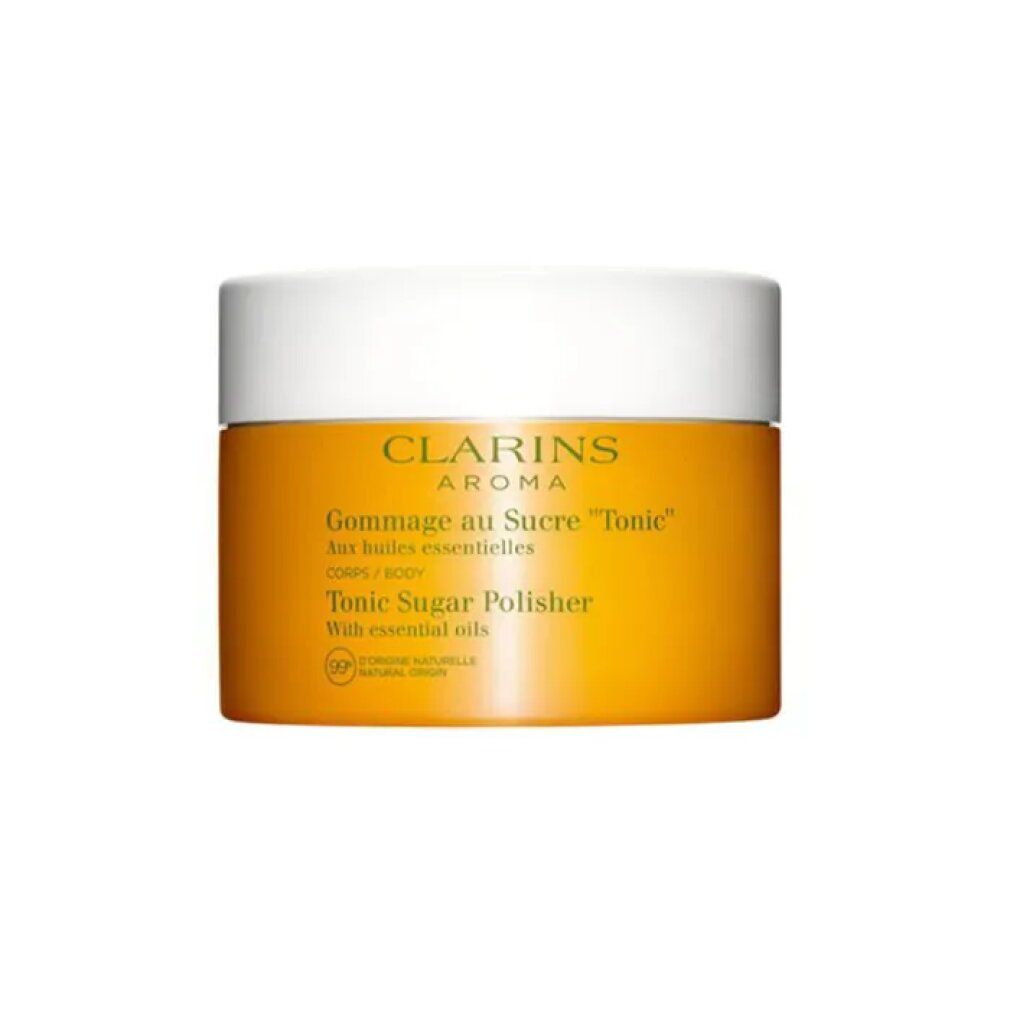 Vasetto giallo con coperchio bianco. Scritta: Clarins Aroma, Gommage au Sucre Tonic, Tonic Sugar Polisher. 99% origine naturale.