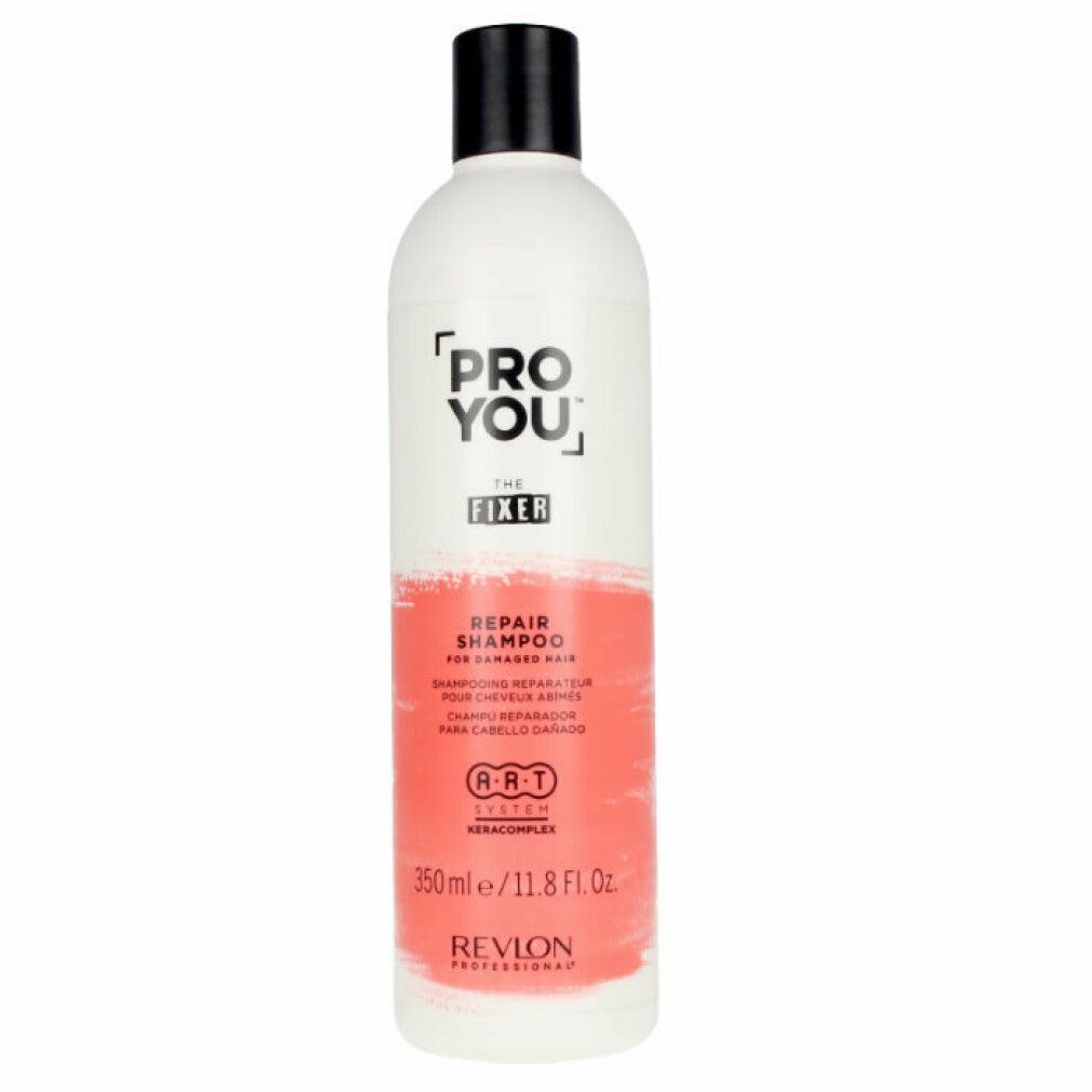 Flacone bianco con tappo nero. Scritta: PRO YOU THE FIXER REPAIR SHAMPOO. Area colorata rossa. Revlon Professional.