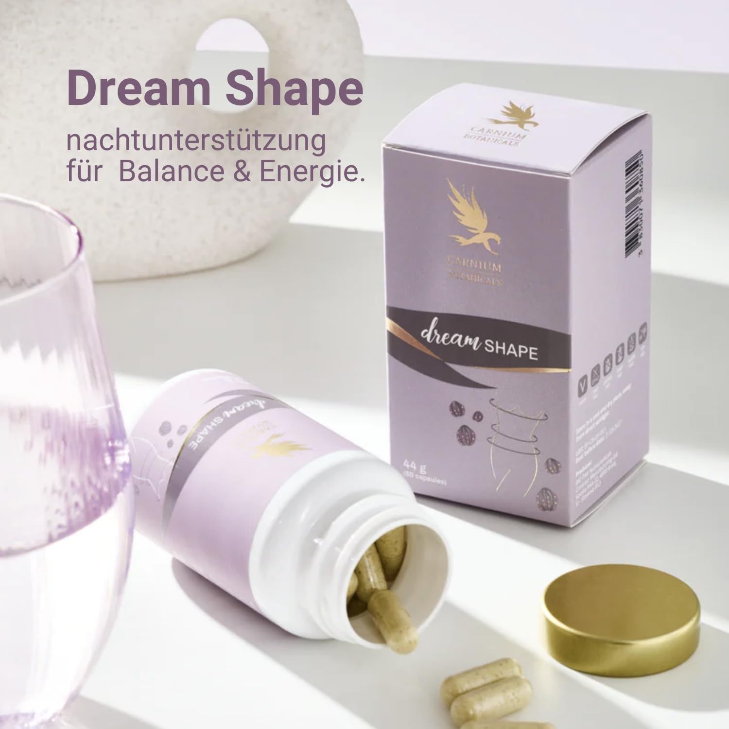 Flacone e scatola Dream Shape. Capsule accanto. Tappo dorato. Etichetta viola con logo e scritta Dream Shape.